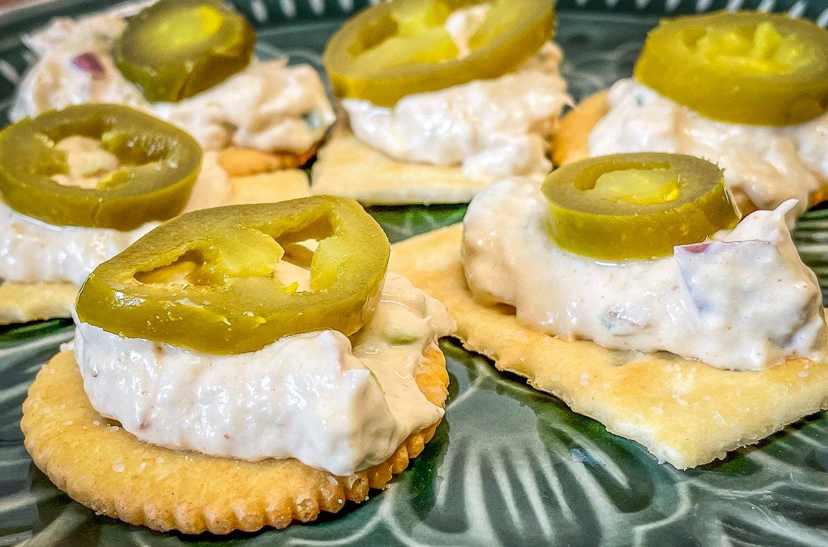 Serve the dip with crackers and add a slice of jalapeño, if desired.