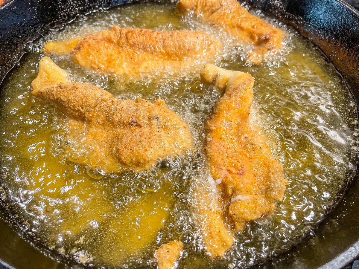 Fry the fish in hot oil until crispy and flaky. 