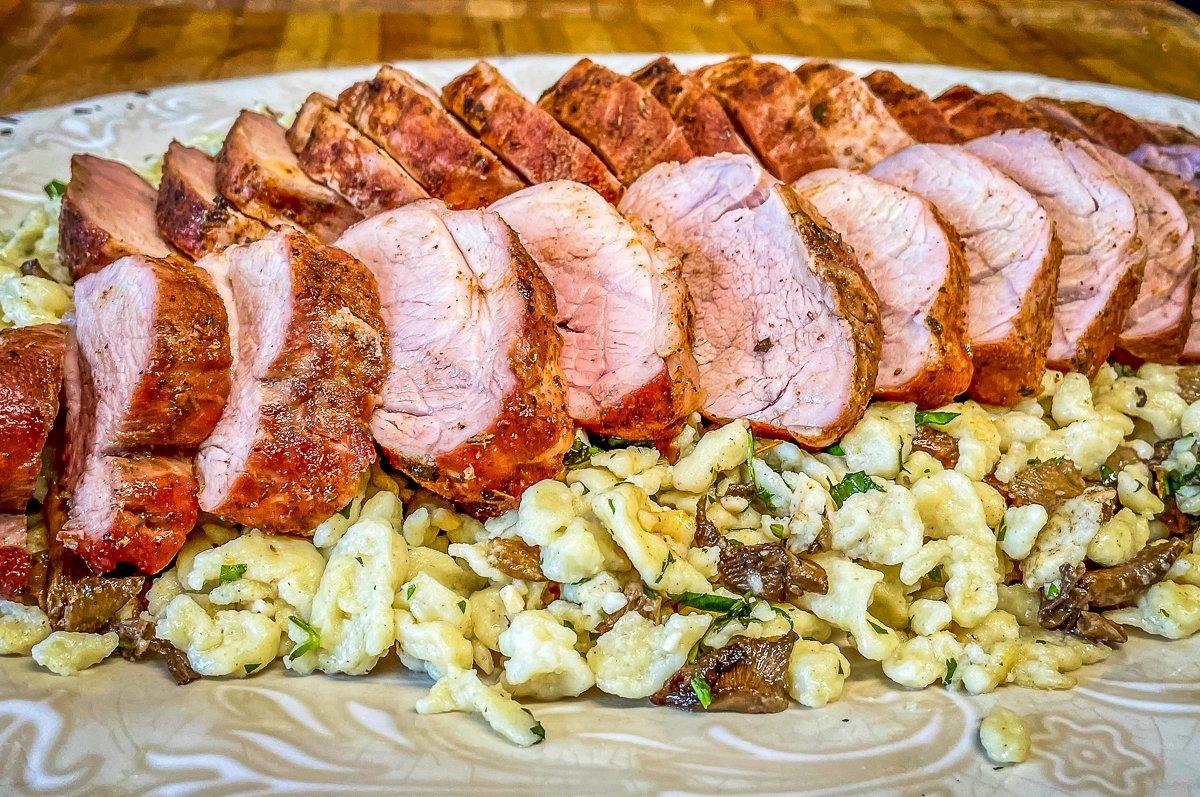 To serve, layer the sliced pork over the mushroom spaetzle. 