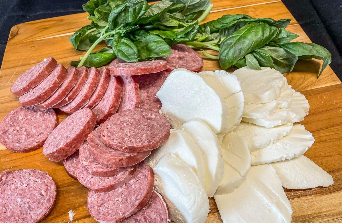Combine your fresh tomatoes with mozzarella cheese, basil and sliced venison sausage.