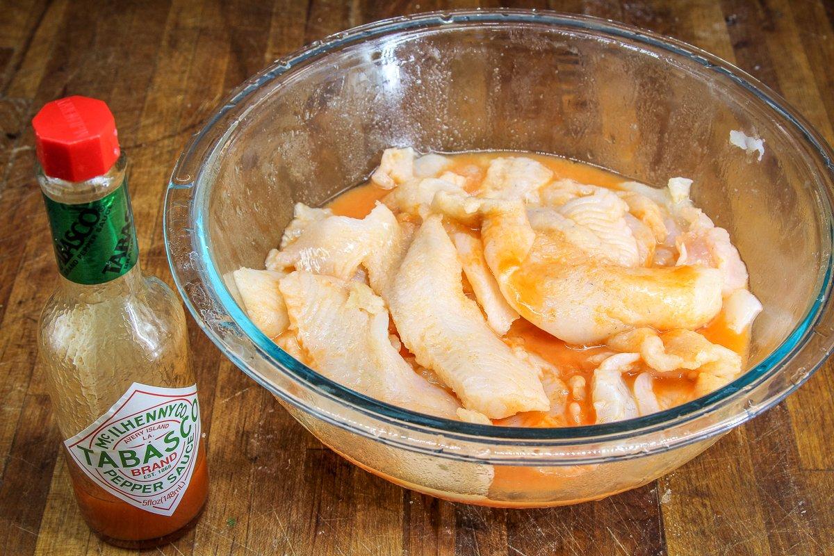 Marinate the fillets in Tabasco sauce.