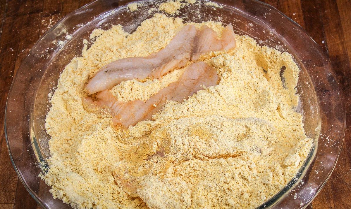 Dredge the fish in seasoned cornmeal.