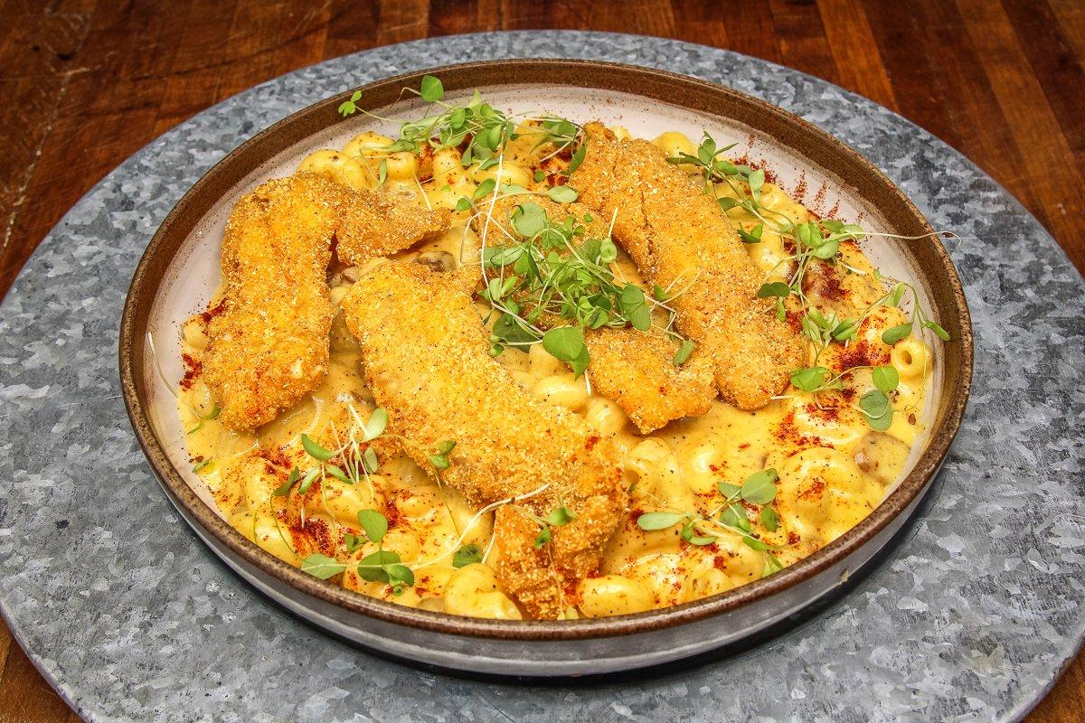 Crispy, spicy fried fish is the perfect match for this creamy mac and cheese with tasso ham.
