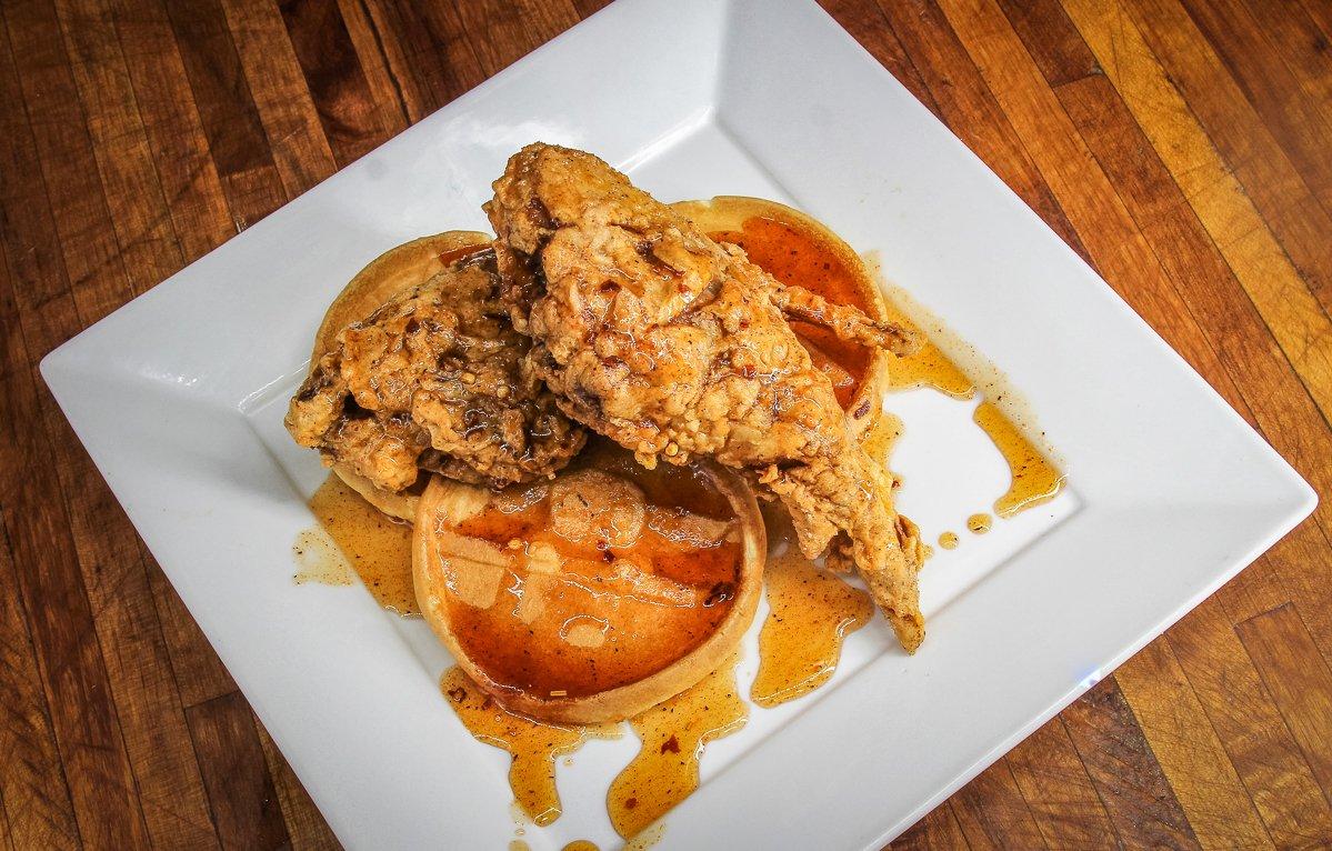 Stack the fried rabbit over waffles and drizzle the Cajun honey over the top.