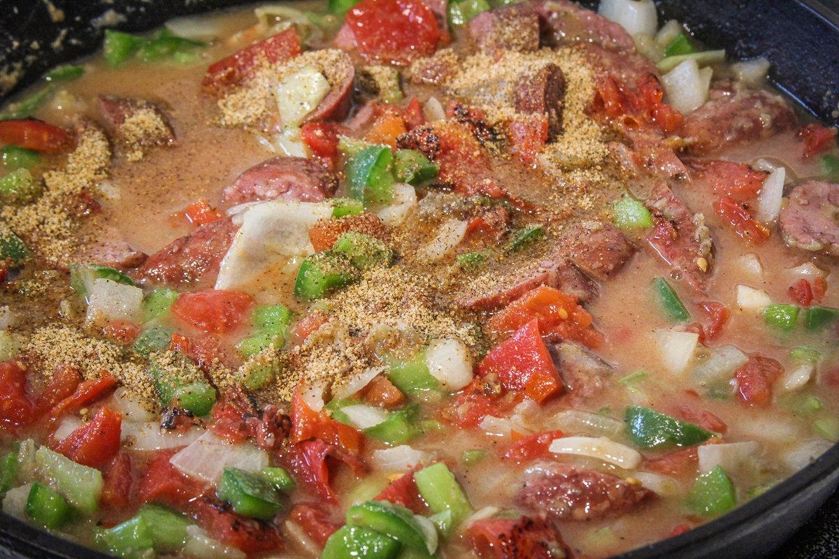 Add the stock, tomatoes, and rice, then simmer with the lid slightly ajar, until the rice is fully cooked.