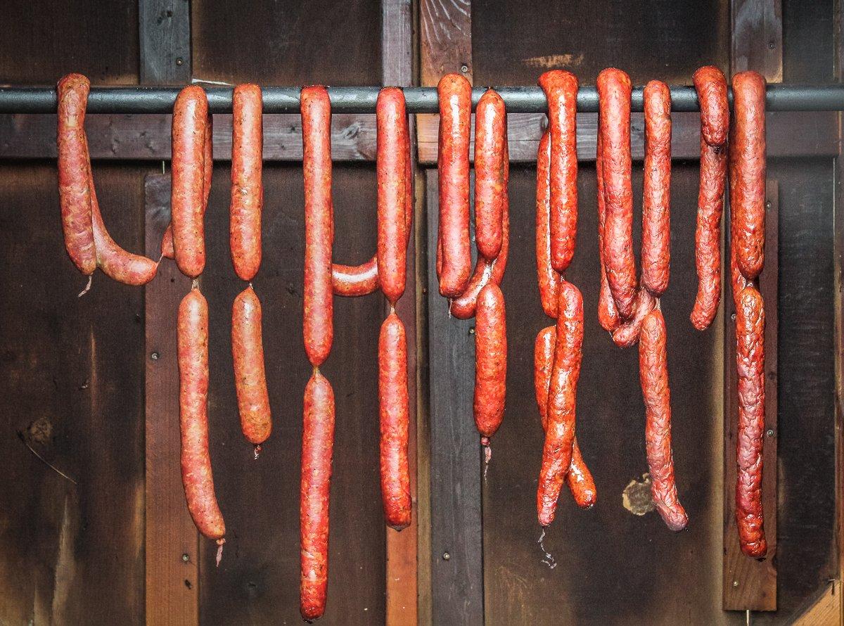 Smoke the sausage until it reaches an internal temperature of 150 degrees and the surface is a deep mahogany red.
