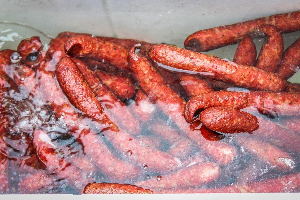 As soon as the sausage reaches an internal temp of 150 degrees Fahrenheit, remove it from the smoker and submerge it in cold water to stop the cooking process.