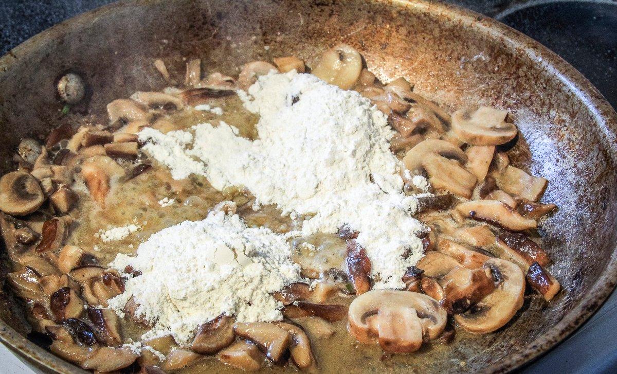 Cook the flour into the mushrooms.