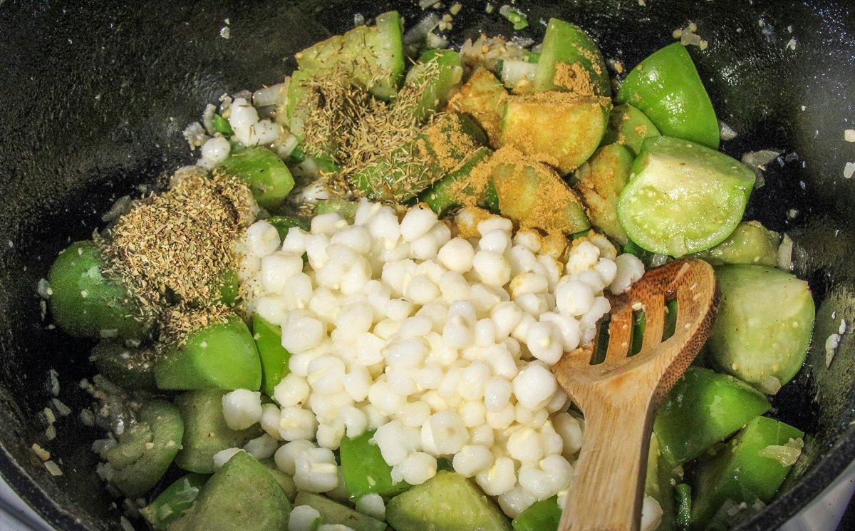 Add the seasonings and hominy to the pot.