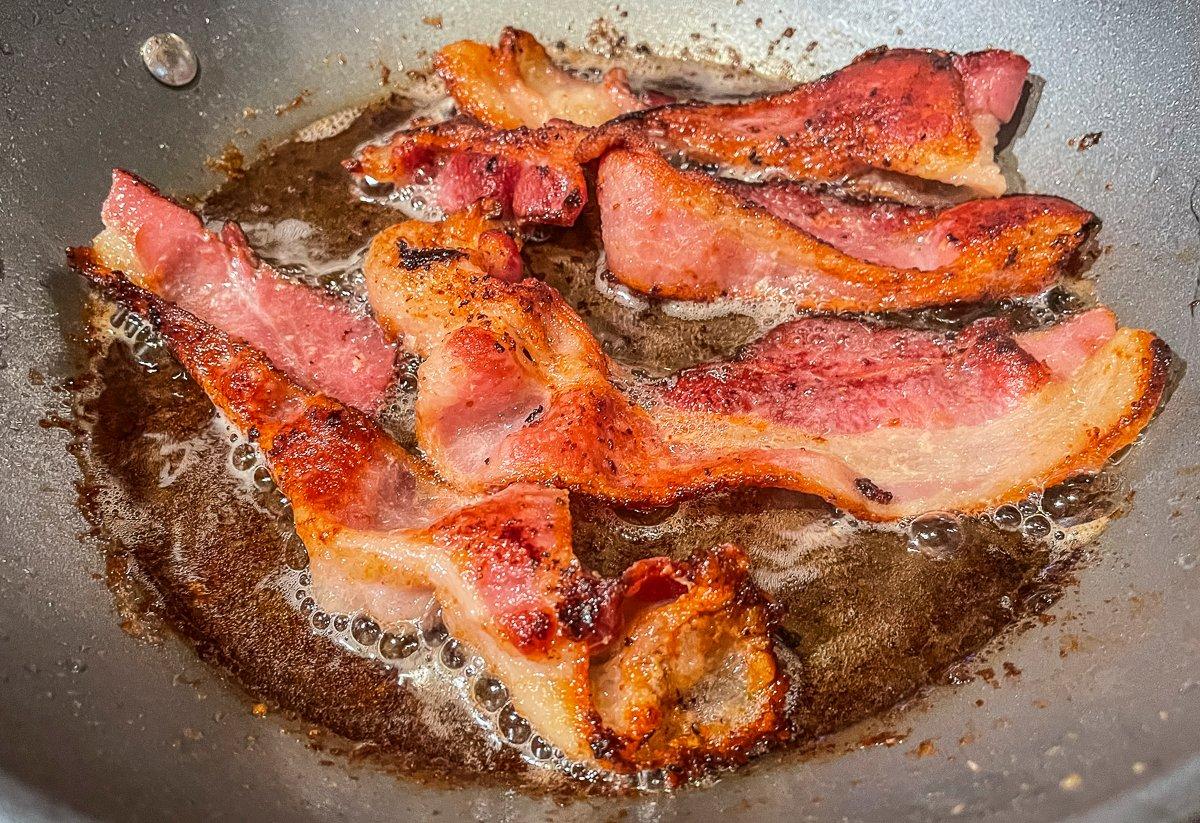 Bacon in a Cast Iron Frying Pan Cooking on a Campfire ! Stock Photo - Image  of black, cooking: 102405834