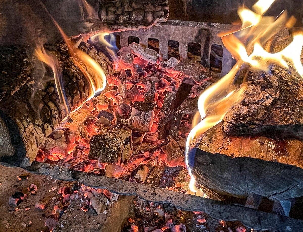 Spread an even bed of coals below the skillet with fire on either side.