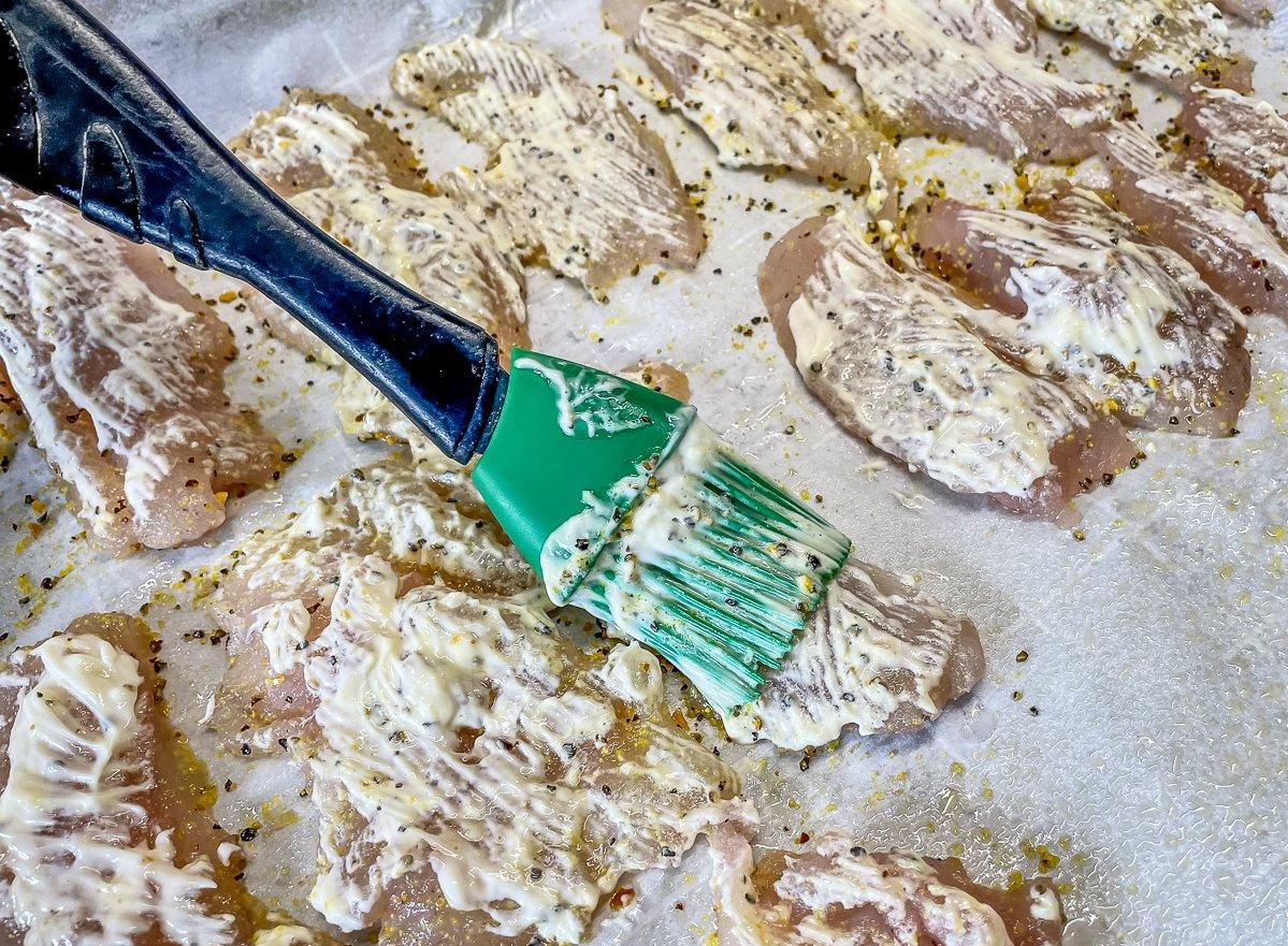 Brush on a thin layer of mayo to help the breading stick to the fish.