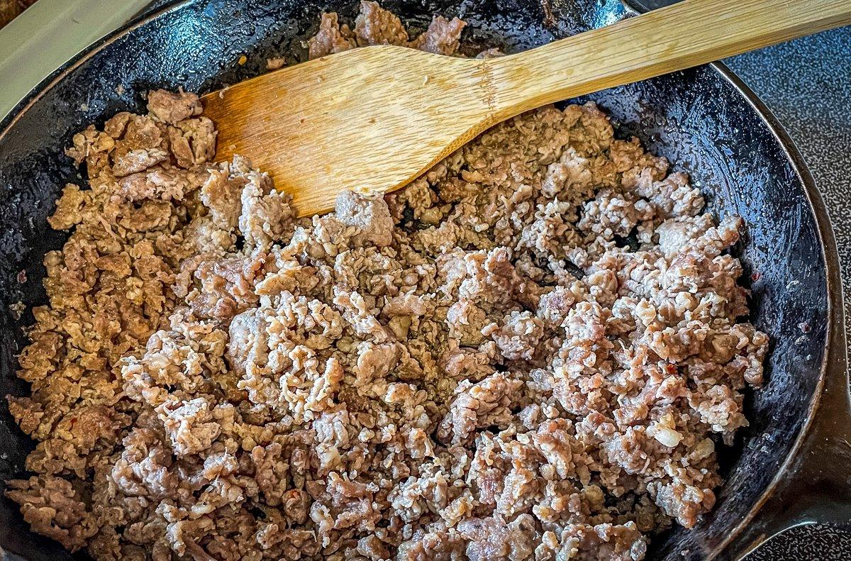 Brown and drain the sausage then remove from heat to cool slightly.