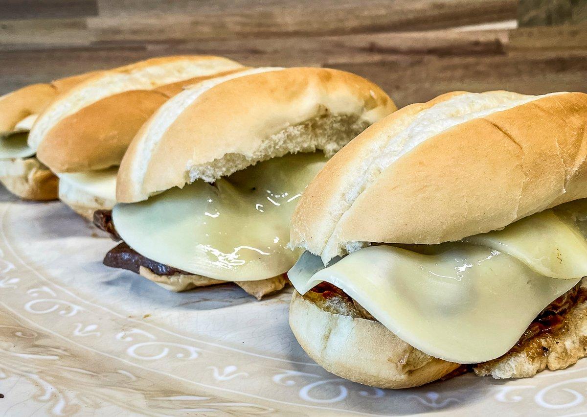Spoon the meat onto buns or rolls and top with cheese.