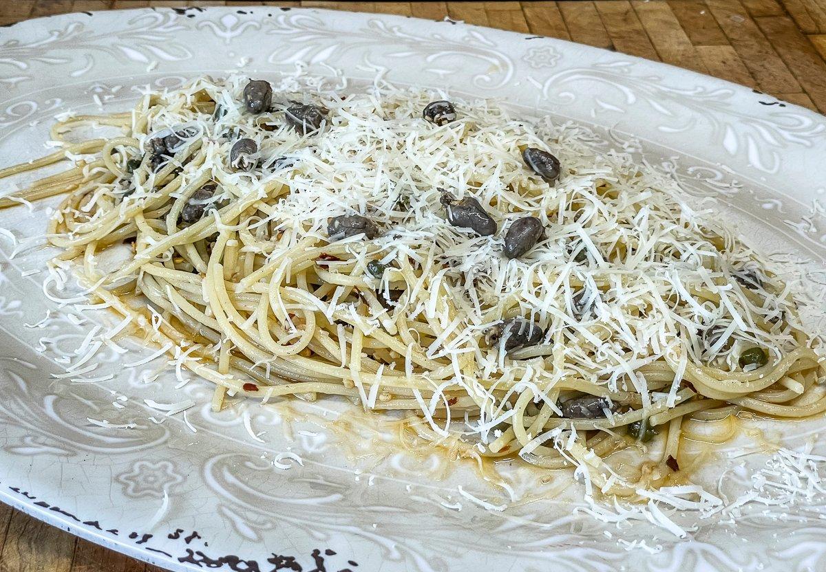 Top the pasta with freshly grated parmesan cheese.