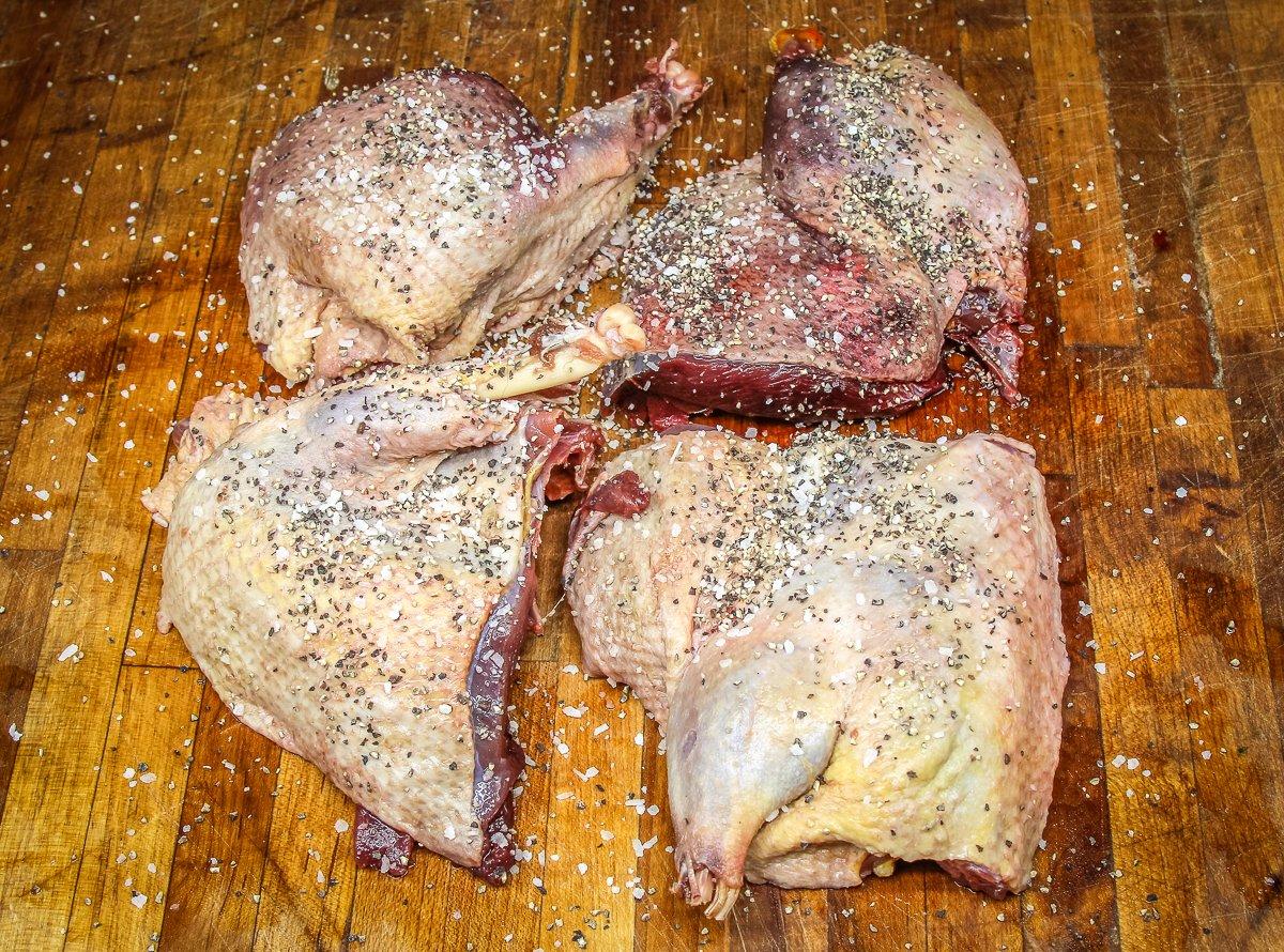 Quarter the duck and season well with salt and pepper.