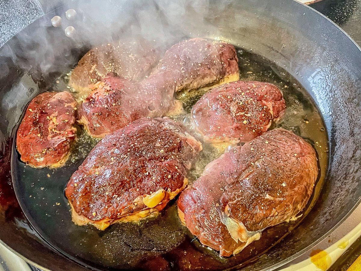 Season and pan sear the duck breasts.