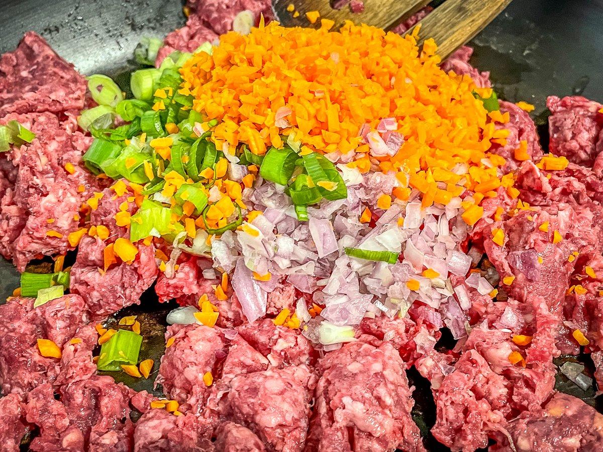 Brown the ground venison with the green onions, shallot and carrots.