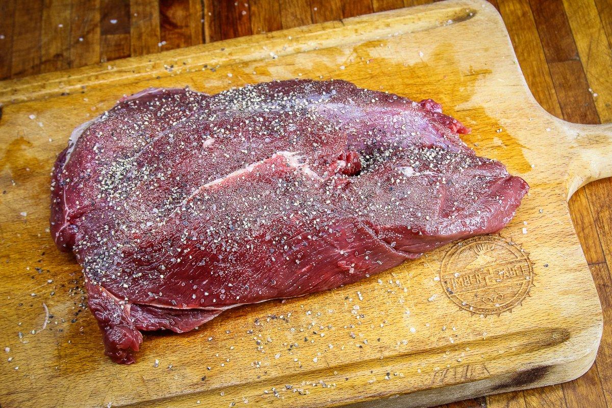 Season the elk roast well with salt and pepper.