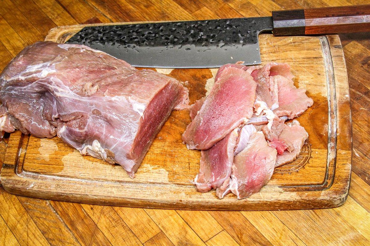 Slice the meat into thin strips by cutting across the grain for tenderness.