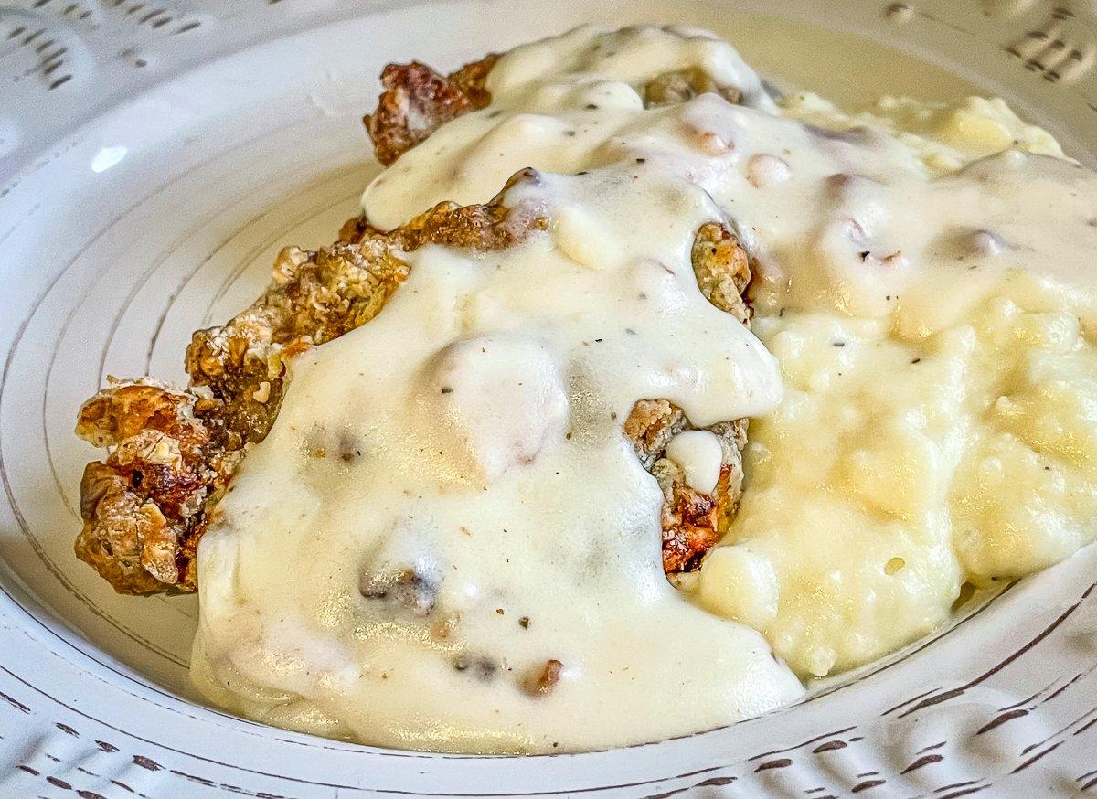 Top tasty air fryer backstrap with creamy bacon gravy.