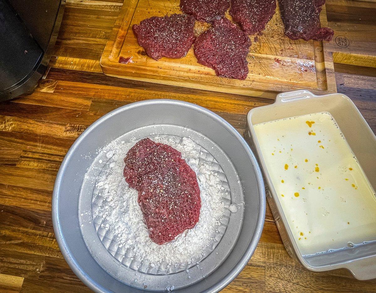 Dip the backstrap in the seasoned flour.