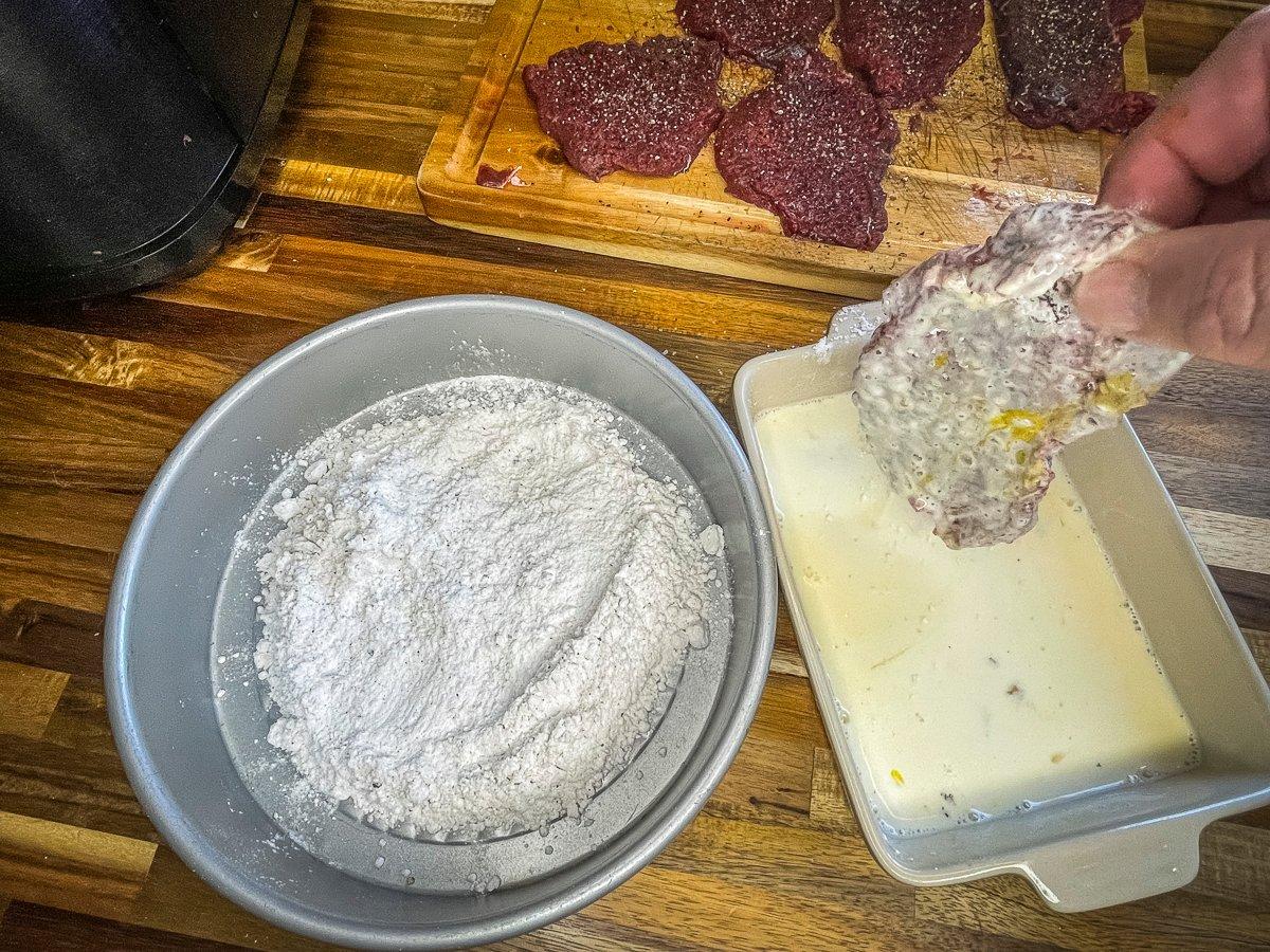 Next, dip the floured steak in the egg/milk mixture, then back into the flour.