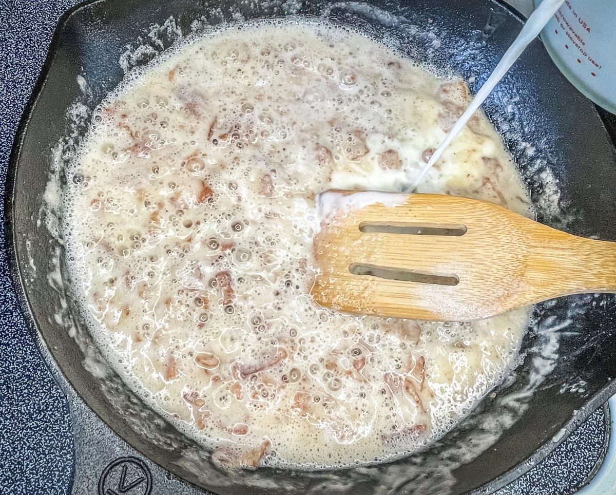 Add flour and milk to the reserved bacon grease.