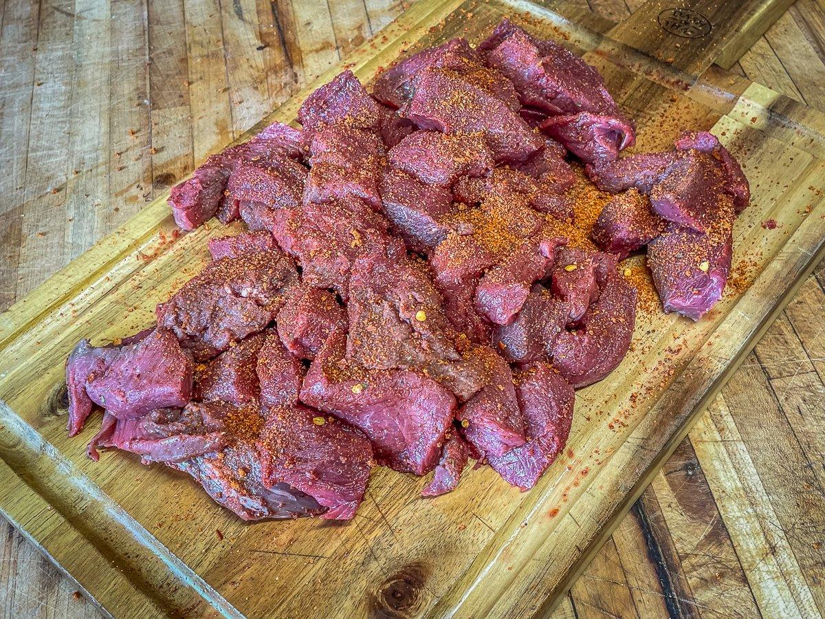 Cut the backstrap into strips and season it well.