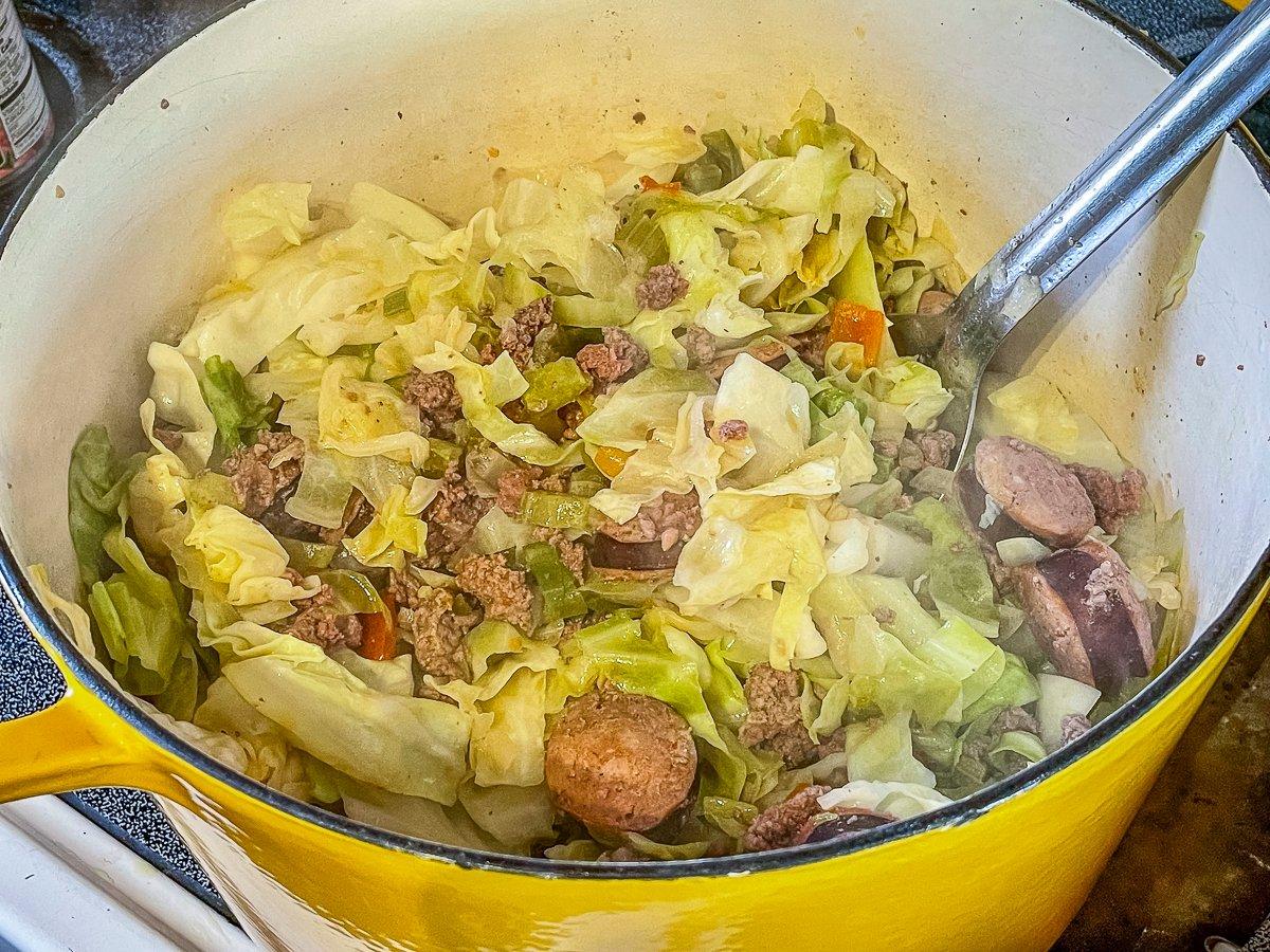 Add the cabbage and cook it down.