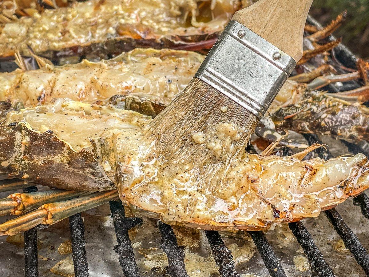 Brush on seasoned garlic butter several times as the lobster grills. 