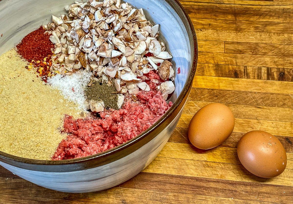 The recipe uses eggs and bread crumbs as binders to help the lean ground elk stick together.