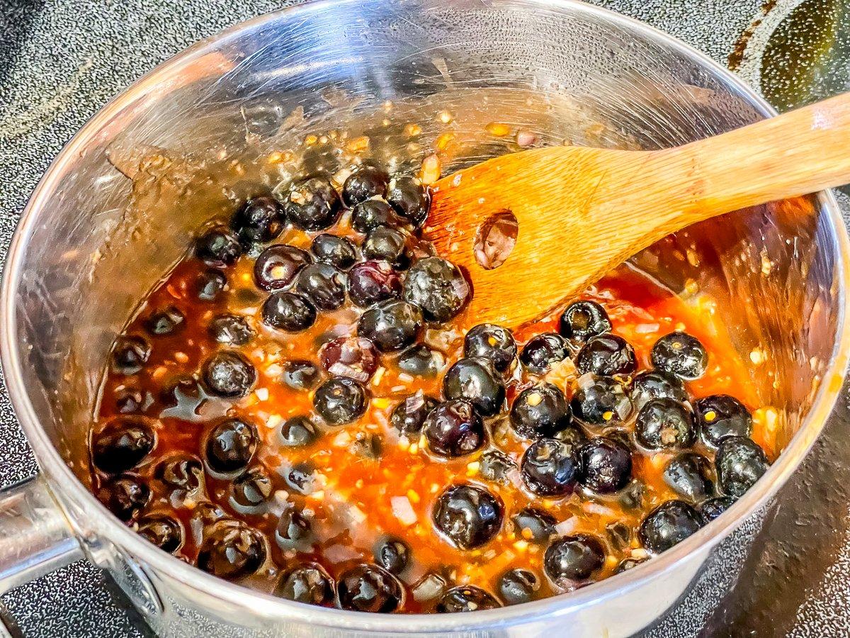 Simmer the sauce until it thickens while the meatballs cook.