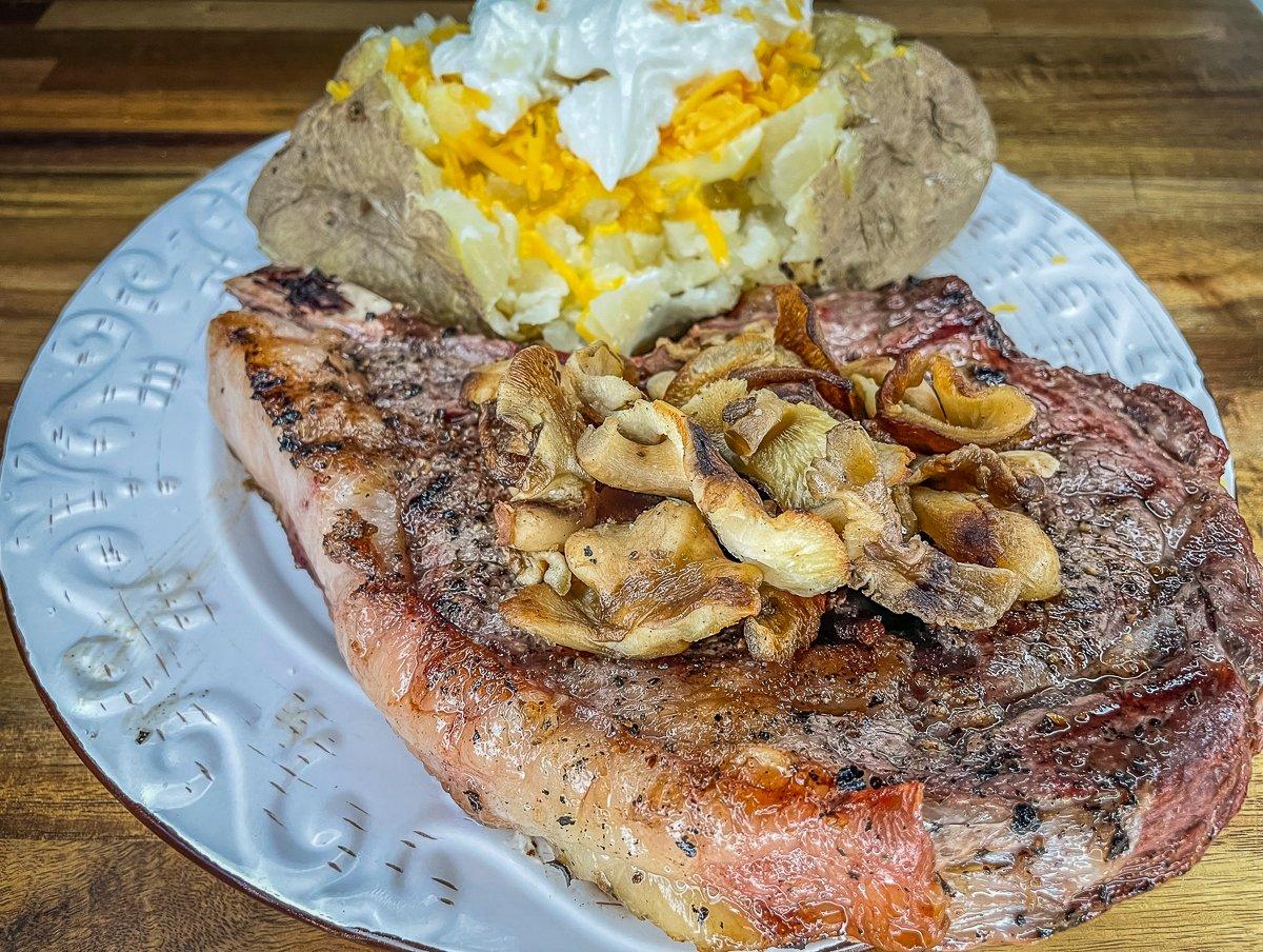 A good steak is even better when topped with buttery sautéed mushrooms.