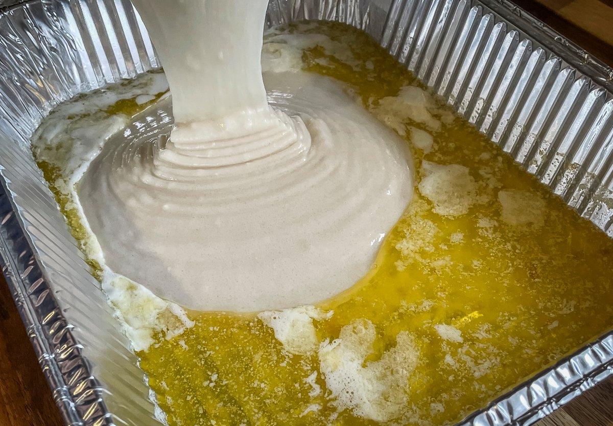 Pour the batter directly into the melted butter.