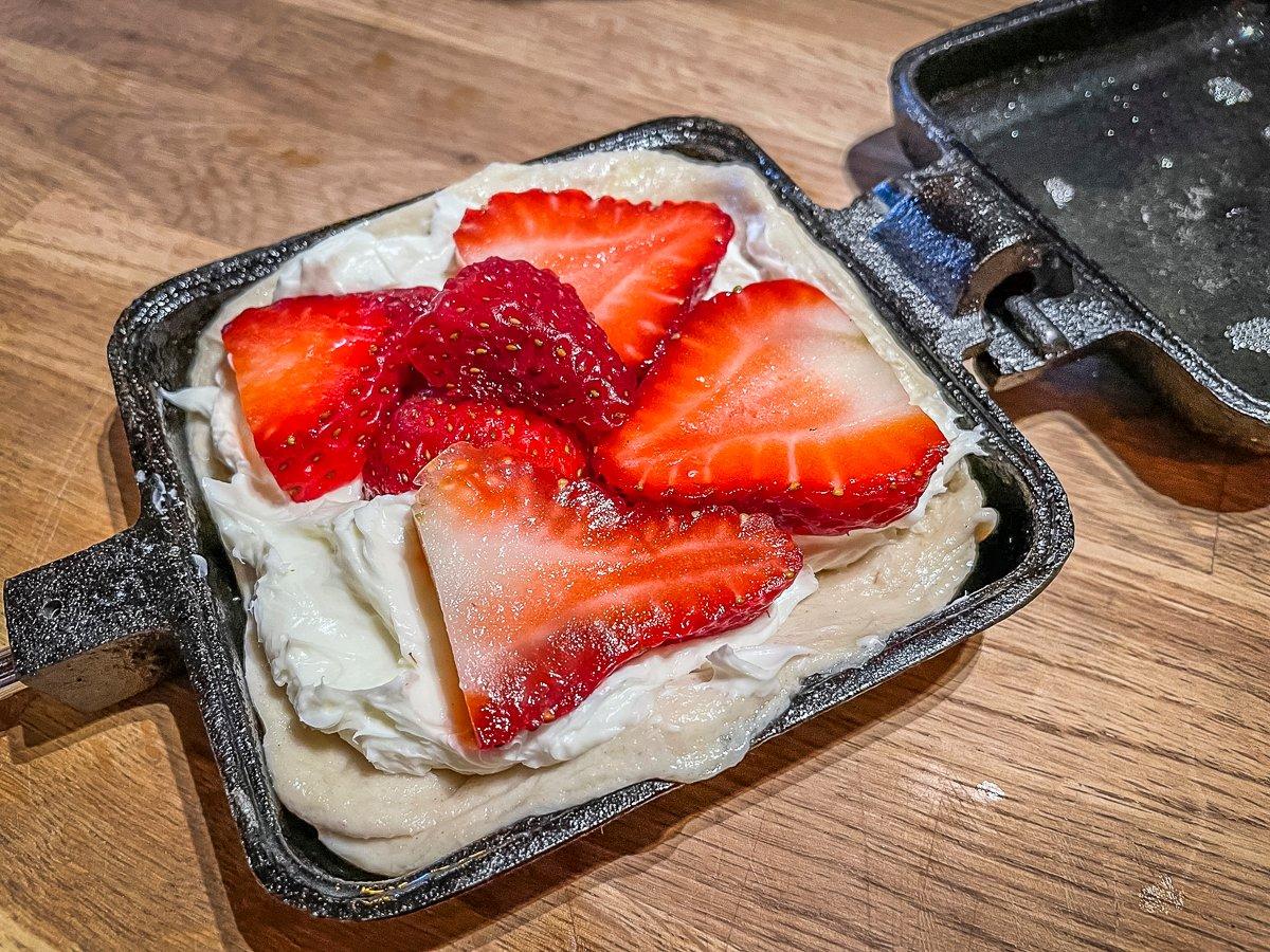 Spread the cream cheese and sliced strawberries onto the dough.