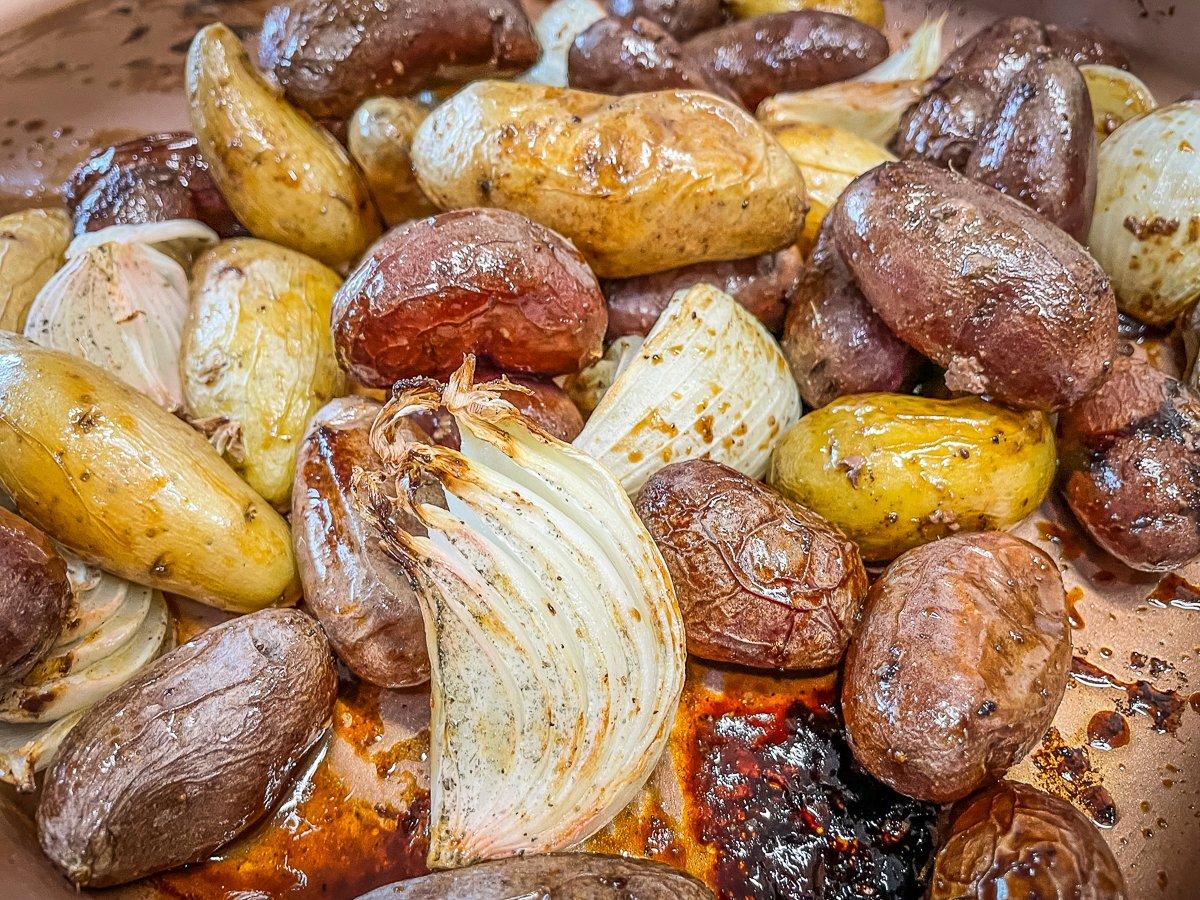 Toss the roasted potatoes and onions in the pork drippings before serving.