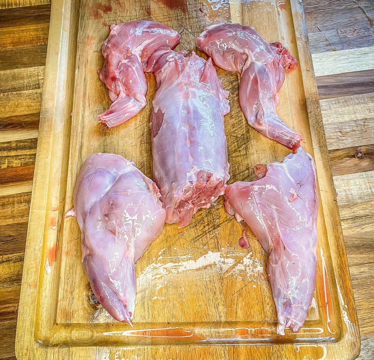 Separate the rabbit into back and leg quarters.
