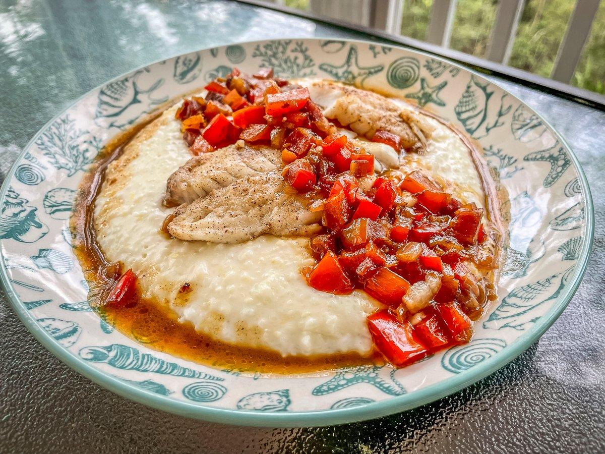 The red-eye gravy sauce is the perfect topping for the flaky fish and creamy grits.