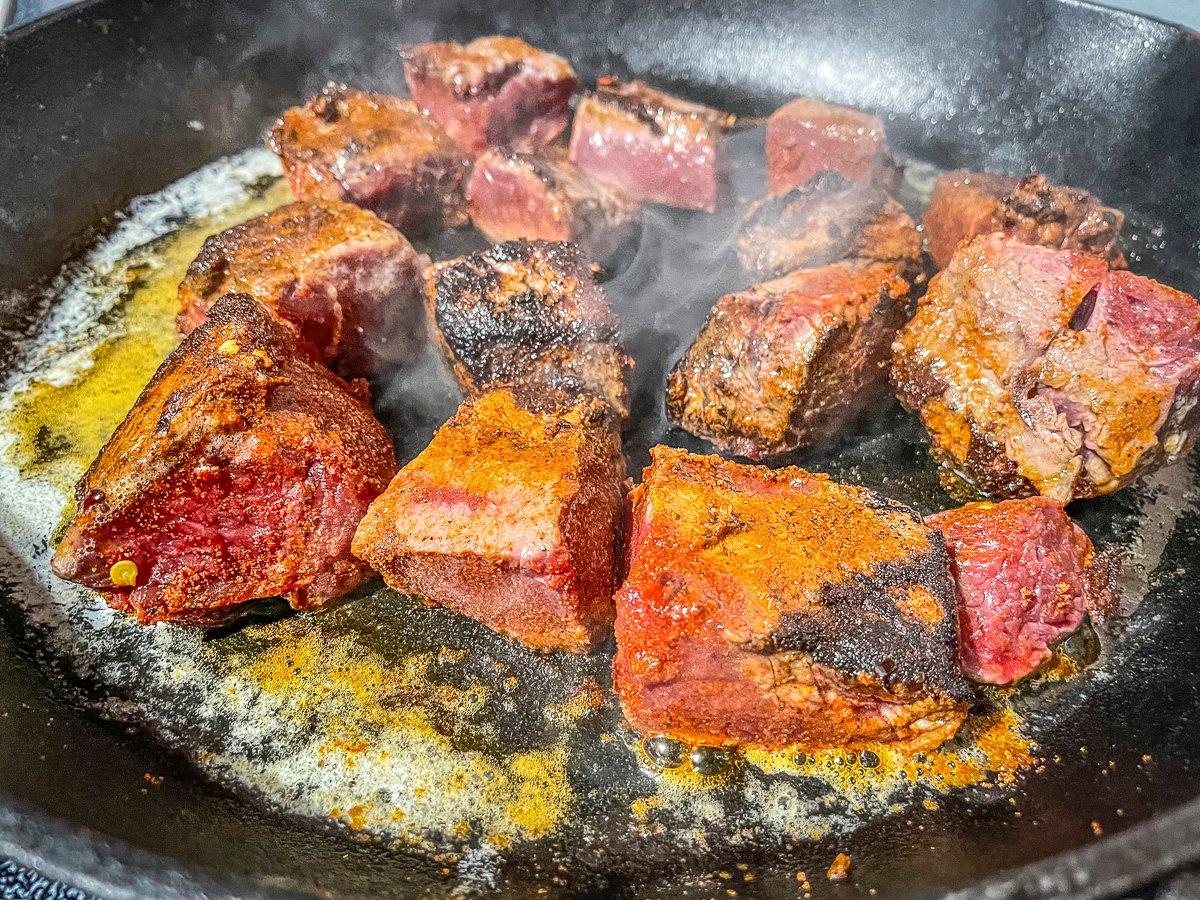 Sear the backstrap in clarified butter.