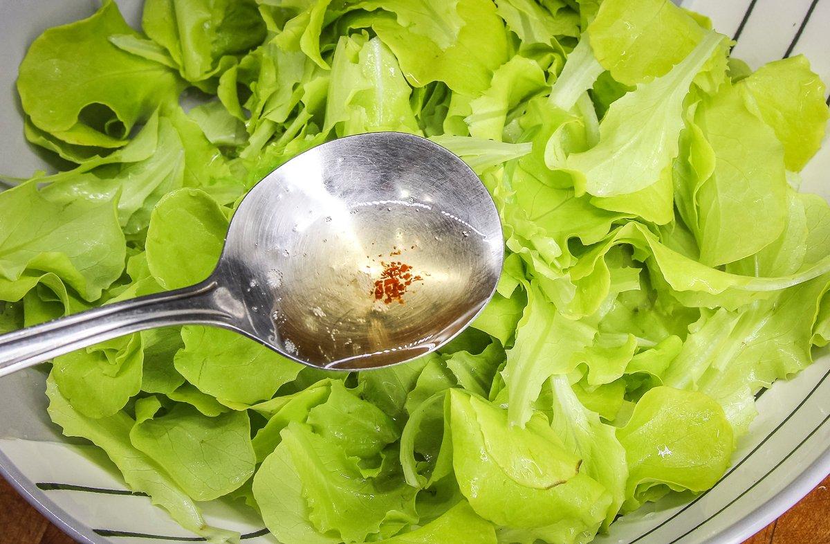 Drizzle the hot grease over the fresh lettuce.