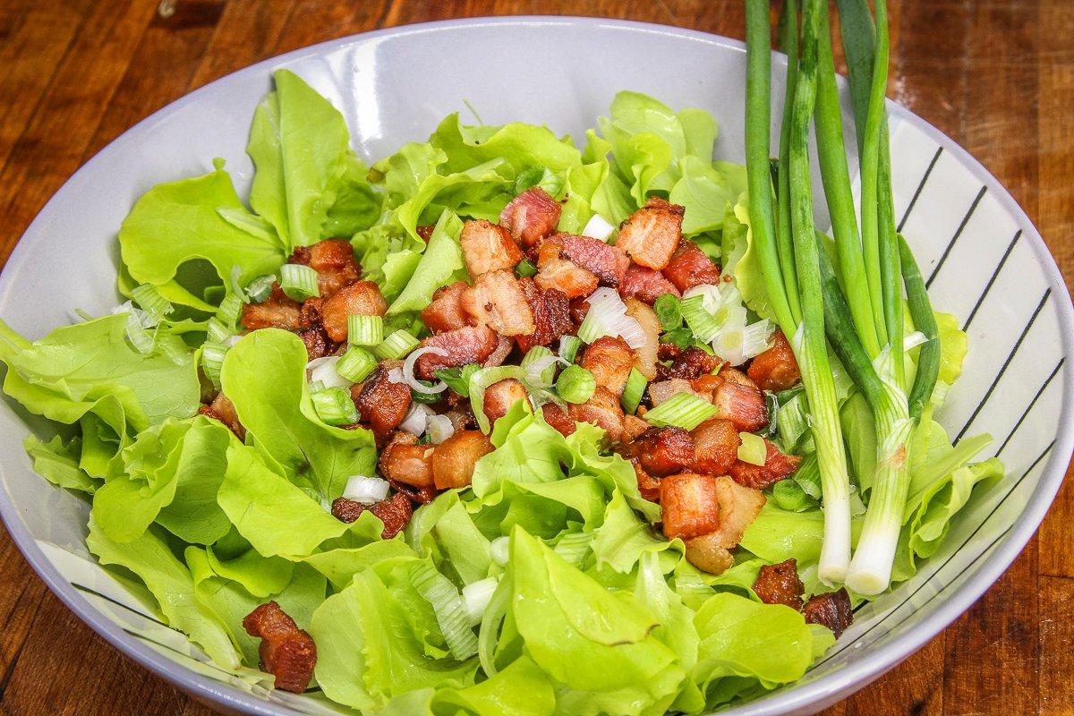 Top the salad with crispy bacon bits and diced green onions.