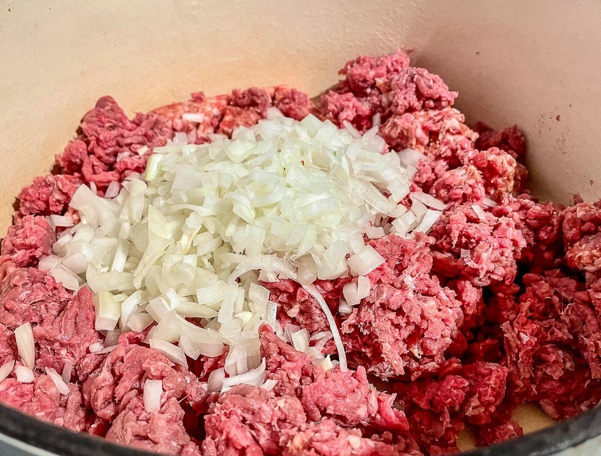 Brown the ground venison and Italian sausage with the onion.