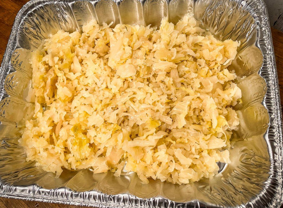 Pour the kraut into a disposable aluminum pan.