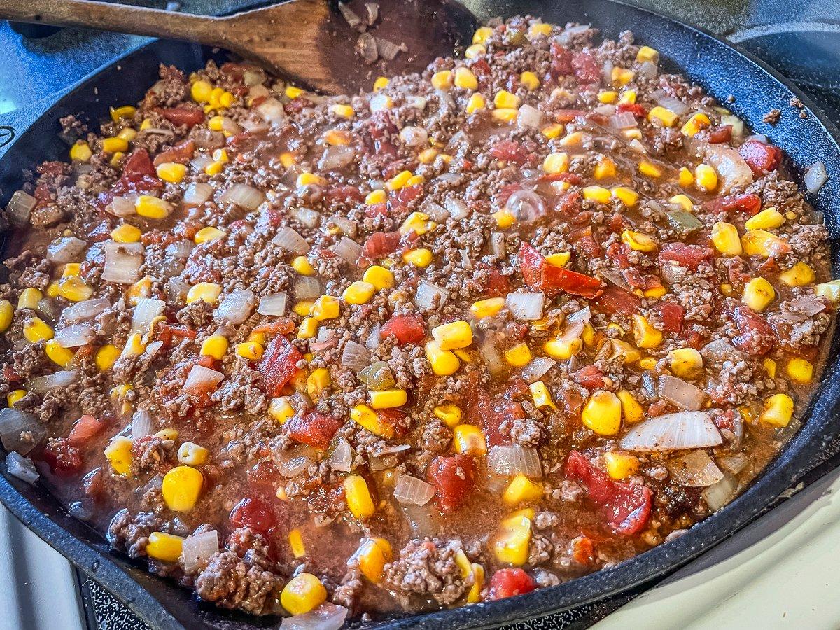Add the tomatoes and corn to the browned venison.