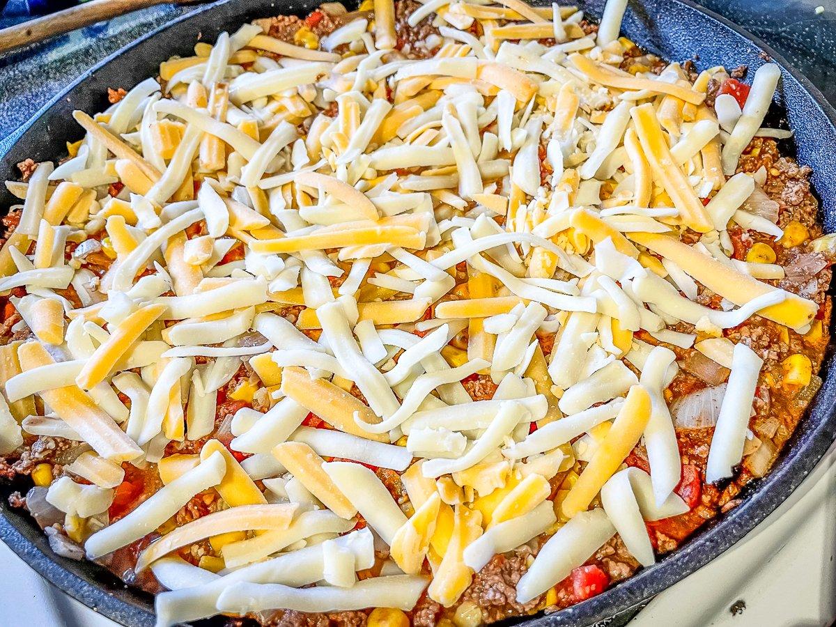 Top the venison filling with shredded cheese.