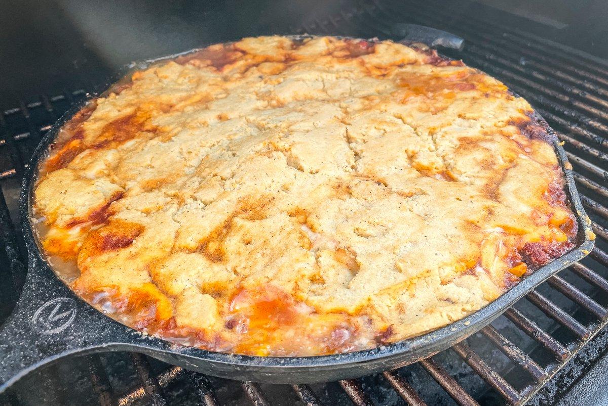 Spread the dough over the filling and grill until golden brown and cooked through.