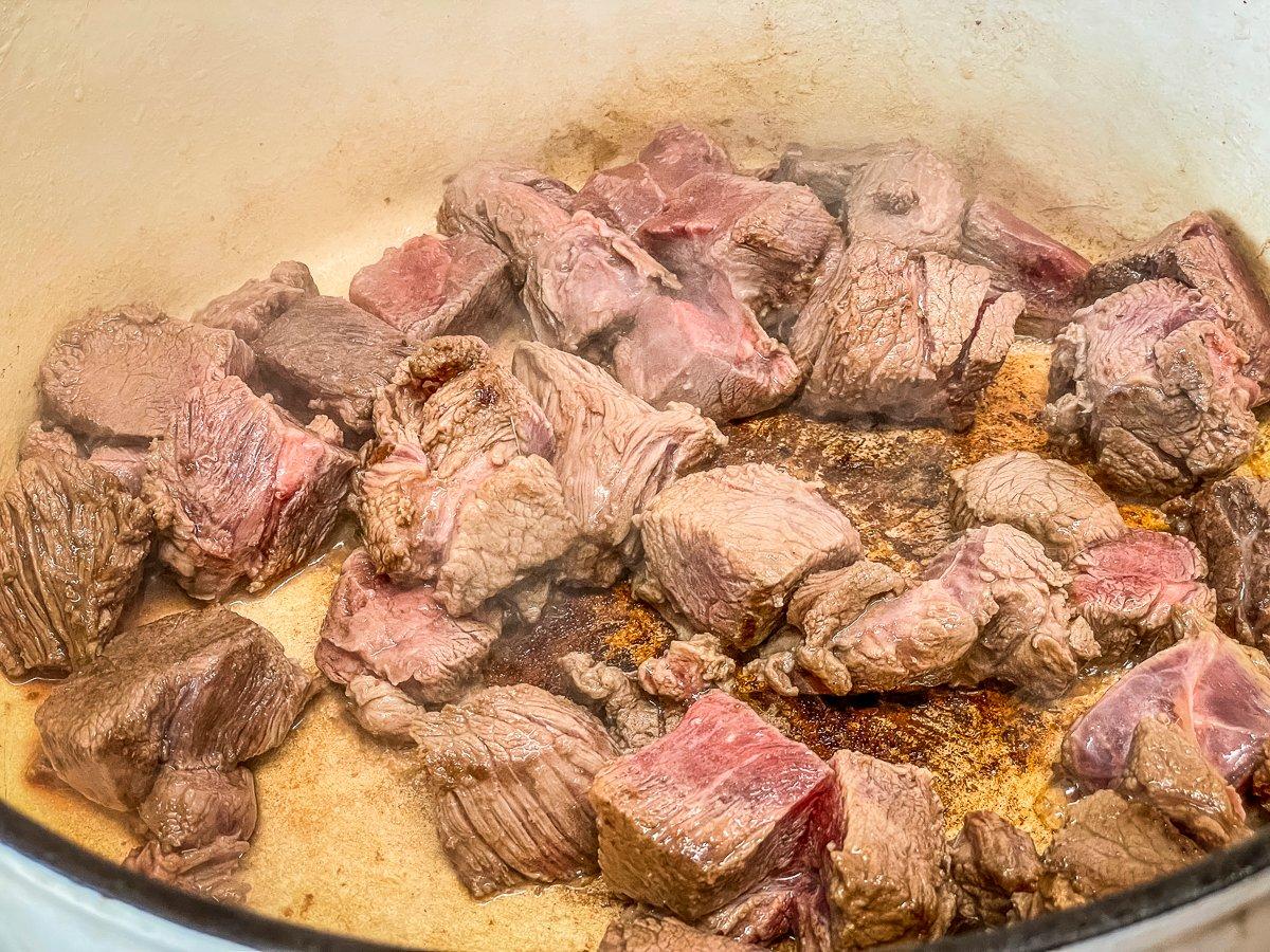 Brown the venison in a large pot.