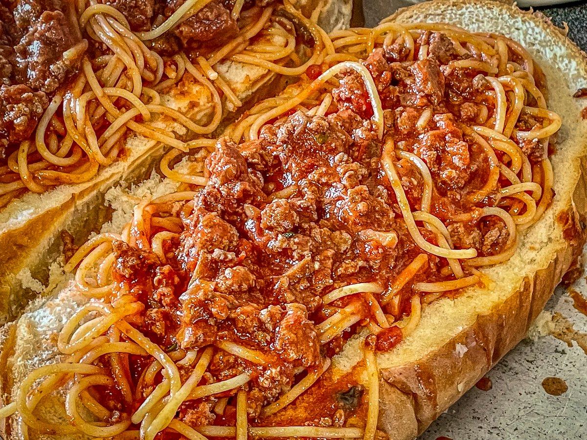 Pile the venison spaghetti onto buttered garlic bread.
