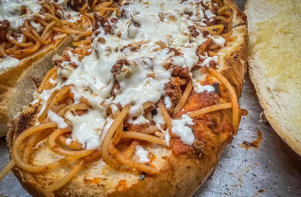 Top the spaghetti with shredded mozzarella and run it under the broiler to melt.